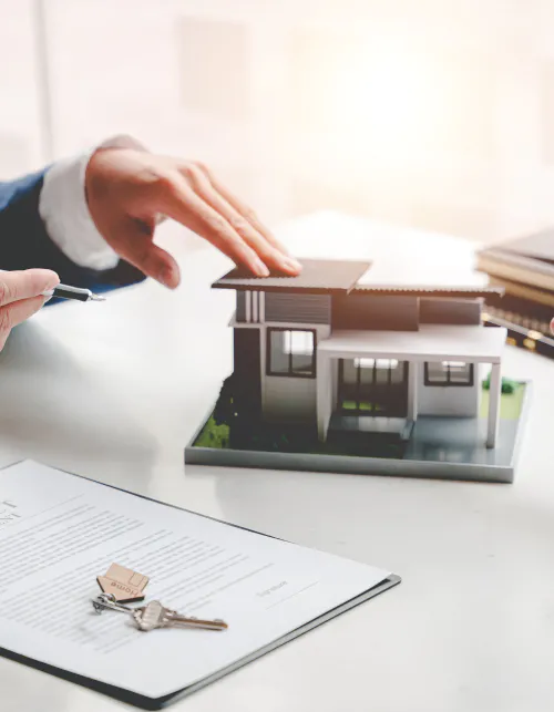 a home appraiser touching a house toy during appraisal review with client draper ut