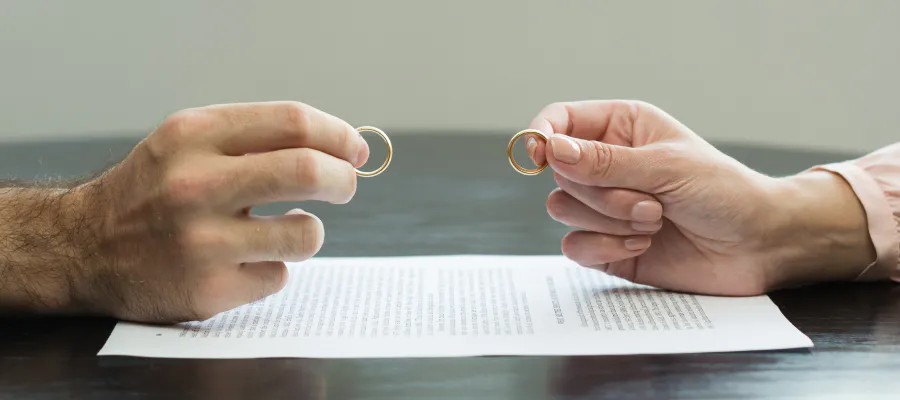 close up of a couple holding their wedding rings during divorce appraisal service draper ut