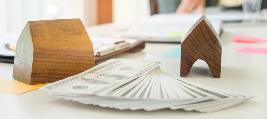 close up of a toy house and several bills during mortgage appraisal service draper ut